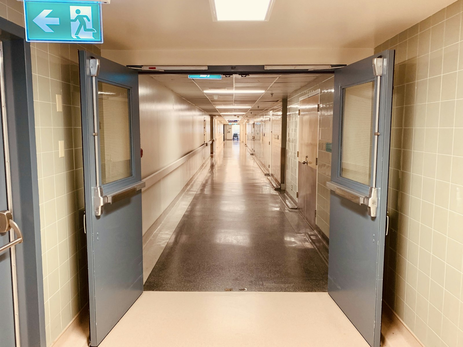 A warmly lit hospital ward corridor
