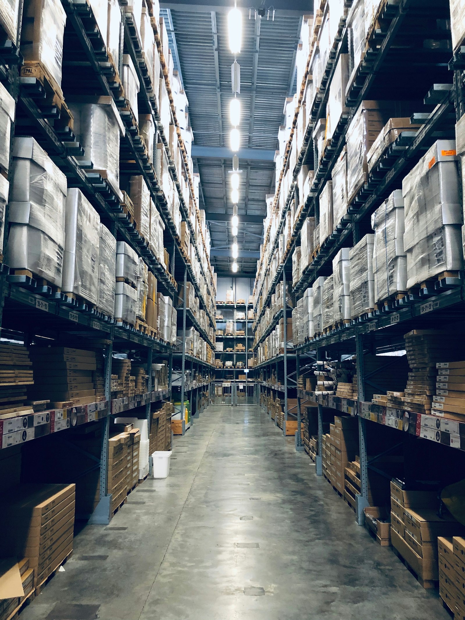 Tall storage racks lining the aisles of a distribution warehouse